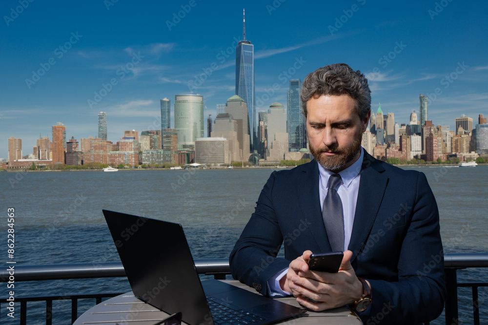 Business man using laptop computer outdoor in New York. American success Businessman . Remote freelance work. Online business in US. Business success. Management strategy. Outside business. Business man using laptop computer outdoor in New York. American success Businessman . Remote freelance work. Online business in US. Business success. Management strategy. Outside business.