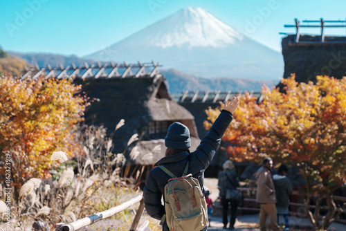 Woman tourist with mount Fuji at Saiko Iyashino Sato Nenba in Autumn season, happy Traveler travel Mt Fuji, Yamanashi, Japan. Landmark for tourist attraction. Japan Travel, Destination and Vacation photo