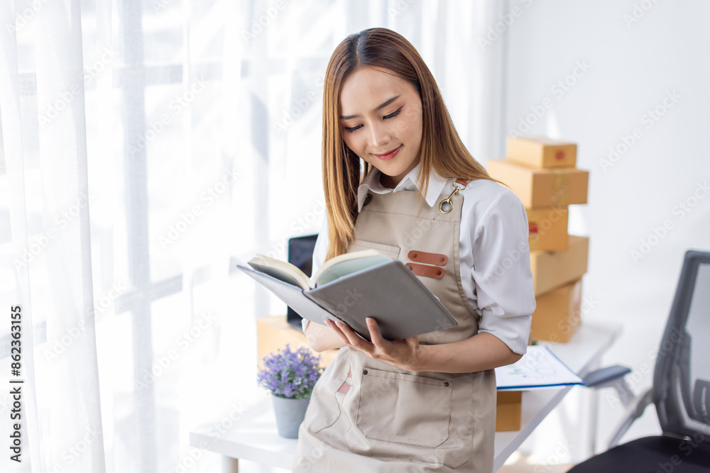 Beautiful Asian online business owner is preparing a parcel box to prepare the package for delivery to the customer asian Entrepreneur SME business concept. Beautiful Asian online business owner is preparing a parcel box to prepare the package for delivery to the customer asian Entrepreneur SME business concept.