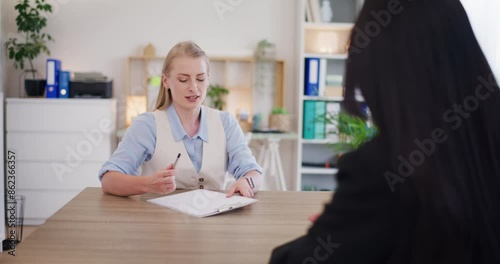 Two Business Women Sign Contract and Shake Hands