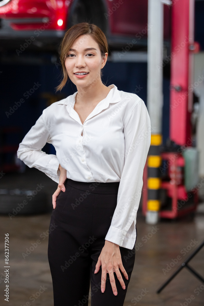 Portrait business woman standing front car at maintenance garage. woman car repair service in automobile garage. Portrait business woman standing front car at maintenance garage. woman car repair service in automobile garage.