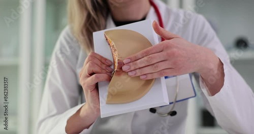 Doctor palpates artificial breast to detect irregularities