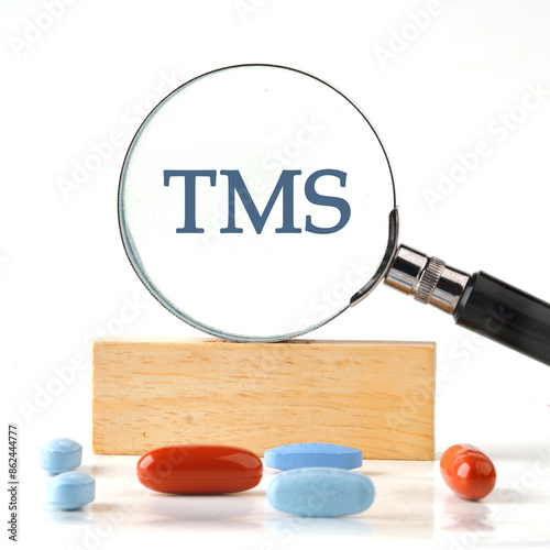 TRM transportation management system. Concept word TMS it manifested itself in a magnifying glass standing on a wooden bar. The aspect ratio of the photo is 1 to 1 photo