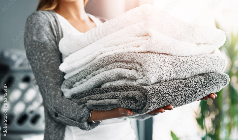 Housekeeping, hands of woman and towels at house for hygiene, fabric and organizing at home. Cleansing laundry, folded cotton and person at laundromat for spring clean, sanitary and textile in stack