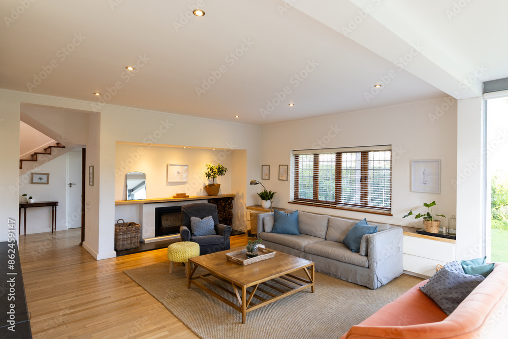 Modern living room with cozy seating, wooden coffee table, and large windows, copy space Modern living room with cozy seating, wooden coffee table, and large windows, copy space