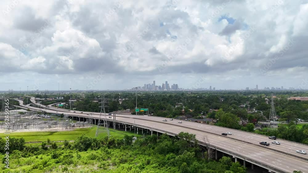 A distant approaching aerial view a downtown skyline, on a cloudy day. A distant approaching aerial view a downtown skyline, on a cloudy day.