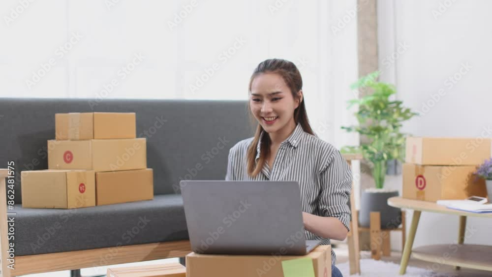 asian young woman owner packing product box prepare to the package for delivery to the customer on sofa at home office asian Entrepreneur SME business concept. asian young woman owner packing product box prepare to the package for delivery to the customer on sofa at home office asian Entrepreneur SME business concept.