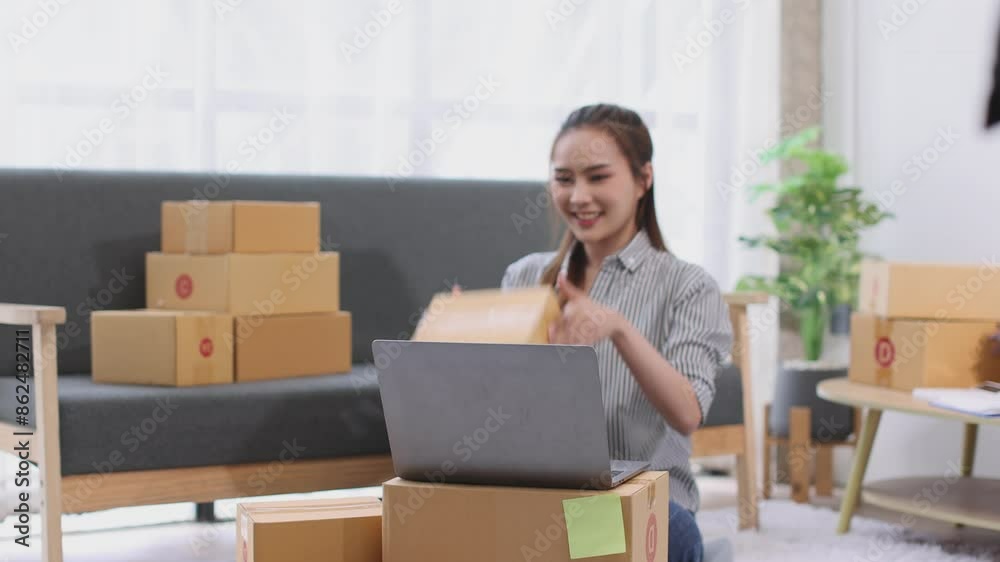 asian young woman owner packing product box prepare to the package for delivery to the customer on sofa at home office asian Entrepreneur SME business concept. asian young woman owner packing product box prepare to the package for delivery to the customer on sofa at home office asian Entrepreneur SME business concept.