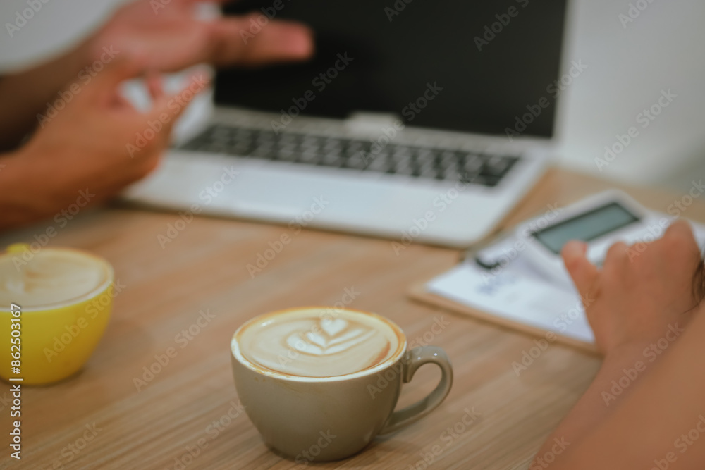 Asian man and woman, enjoy a morning meeting at a cafe, holding cups of hot lattes, clinking together in a cheerful, relaxed atmosphere with a blurred background. Asian man and woman, enjoy a morning meeting at a cafe, holding cups of hot lattes, clinking together in a cheerful, relaxed atmosphere with a blurred background.