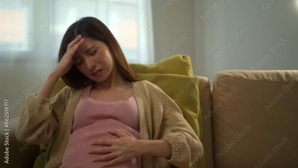 Young pregnant woman suffering from headache and abdominal pain alone at home, tired and stressed female during pregnancy, accidental medical urgency case and health care insurance for pregnancy.
Young pregnant woman suffering from headache and abdominal pain alone at home, tired and stressed female during pregnancy, accidental medical urgency case and health care insurance for pregnancy.