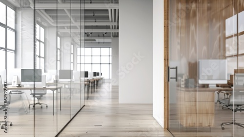 Modern office interior with wooden floors, glass partitions, and computer workstations © Artyom