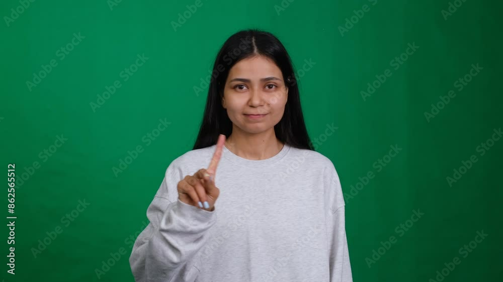 Woman points her finger, showing disapproval and giving advice. Her expression is displeased and frowning, conveying emotion and warning. An indoor, isolated studio shot Woman points her finger, showing disapproval and giving advice. Her expression is displeased and frowning, conveying emotion and warning. An indoor, isolated studio shot