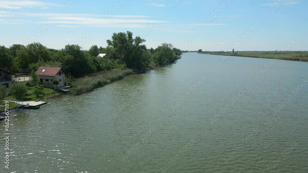 Houses and piers surrounded with reeds and bushes on a shore of lake Houses and piers surrounded with reeds and bushes on a shore of lake