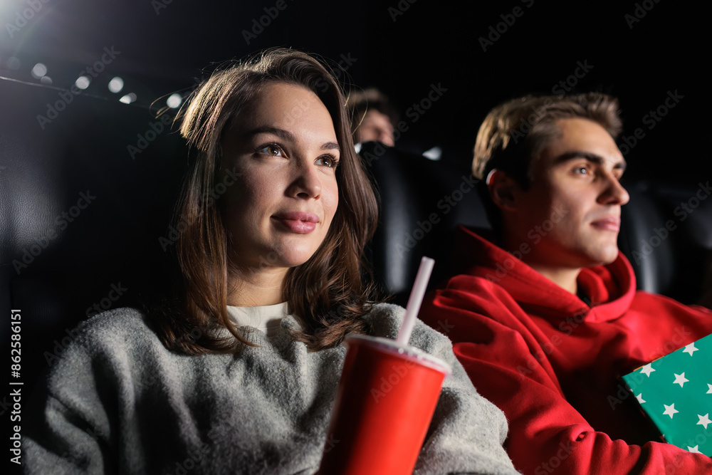 Close-up of a young woman while watching a melodrama at the cinema Close-up of a young woman while watching a melodrama at the cinema