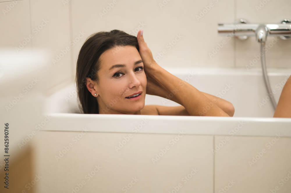 Dark-haired woman feeling relaxed in the bathroom Dark-haired woman feeling relaxed in the bathroom