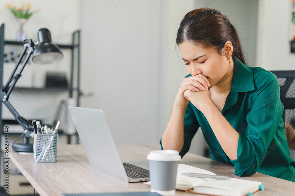 Stressed woman working at home desk, looking at notebook and laptop, managing tasks in home office. Stressed woman working at home desk, looking at notebook and laptop, managing tasks in home office.