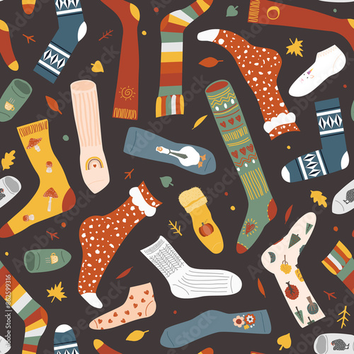 Seamless pattern with autumn leaves and different doodle hand drawn socks on dark background. Funny clothing background.