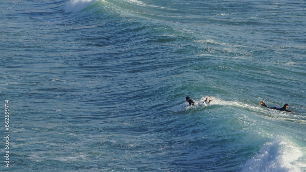 Naklejka premium Surfing / Riding waves at Banana Beach Agadir Morocco