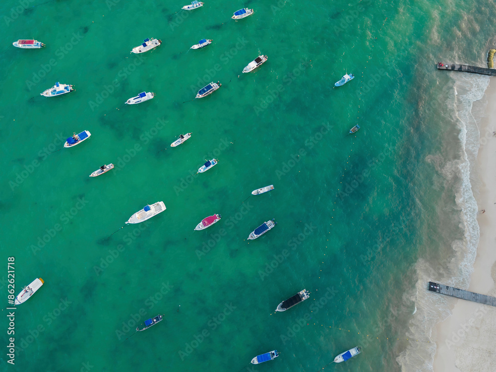 Aerial view of boats on sandy beach with turquoise waters, Playa del Carmen, Mexico.