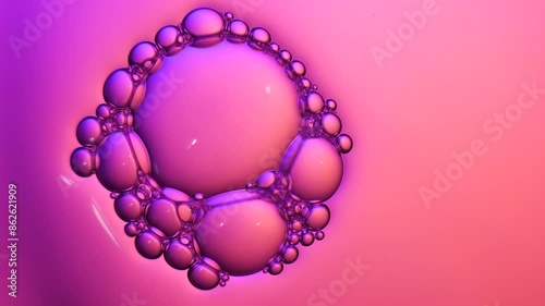 Top view pink soap bubbles floating on the water, color light background