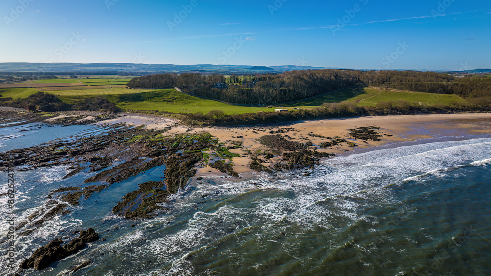 Aerial view of Seacliff Beach with rugged rocks and crashing waves, East Lothian, United Kingdom. Aerial view of Seacliff Beach with rugged rocks and crashing waves, East Lothian, United Kingdom.