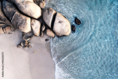 Aerial view of Llandudno beach with rocky coastline and clear water, Hout Bay, South Africa. photo