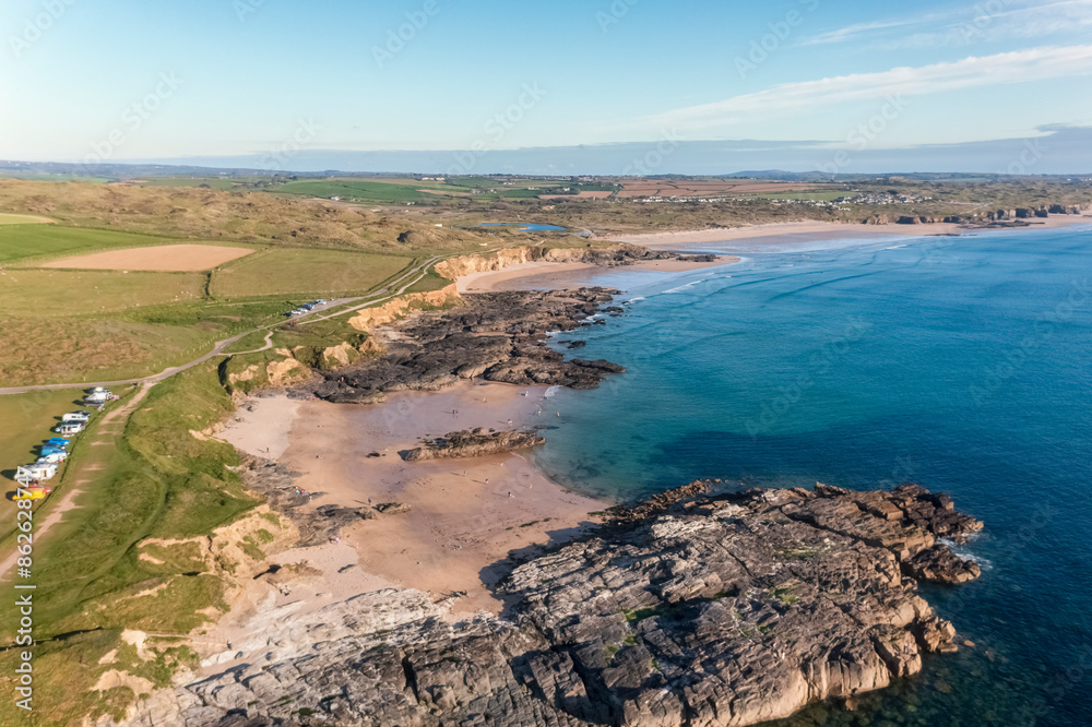 Aerial view of beach, cliffs, vans, and people at Cornwall, Godrevy Lighthouse, England. Aerial view of beach, cliffs, vans, and people at Cornwall, Godrevy Lighthouse, England.