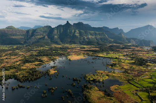 Aerial view of lush greenery and serene lake with reflection, Harishchandragad, Wildlife Sancutary, Nashik district, Maharashtra, India.