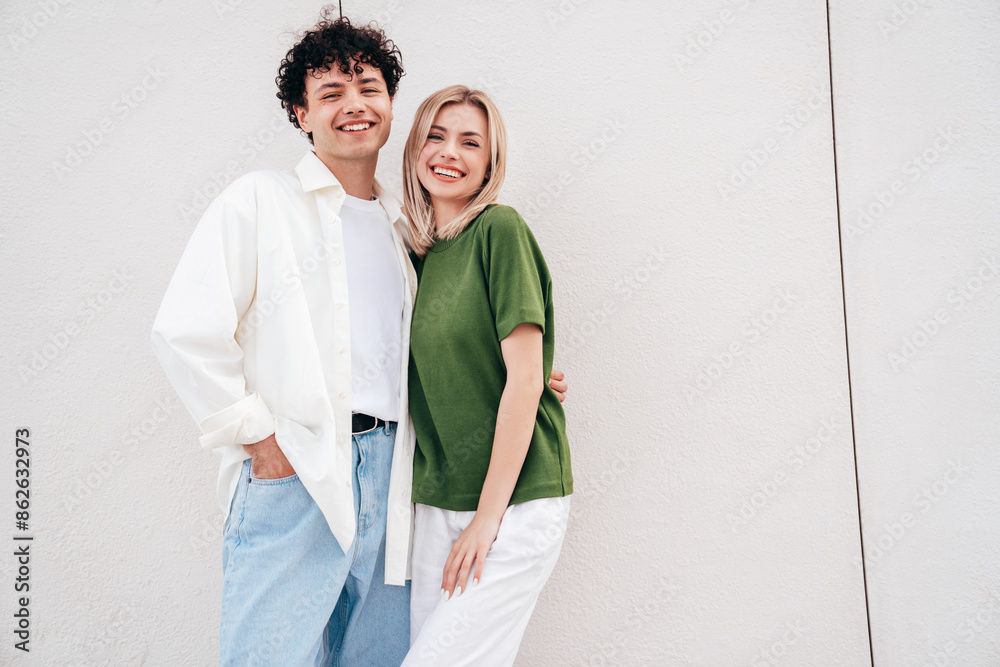 Smiling beautiful woman and her handsome boyfriend. Couple in casual summer clothes. Happy cheerful family. Female and man having fun. They posing in the street in sunny day. Having tender moments Smiling beautiful woman and her handsome boyfriend. Couple in casual summer clothes. Happy cheerful family. Female and man having fun. They posing in the street in sunny day. Having tender moments