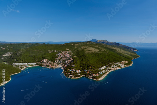 Aerial view of tranquil bay and coastline with mountains and forest in Rabac, Istria, Croatia. photo