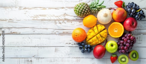 Fototapeta Naklejka Na Ścianę i Meble -  Different fruits displayed on a white wooden surface with ample copy space image.