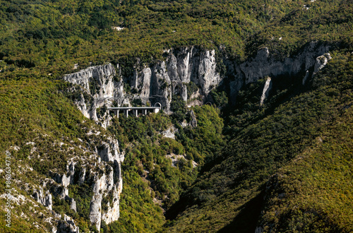 Aerial view of remote, rugged tunnel and cliffs in forested valley, Vranjska Vala, Istria, Croatia.