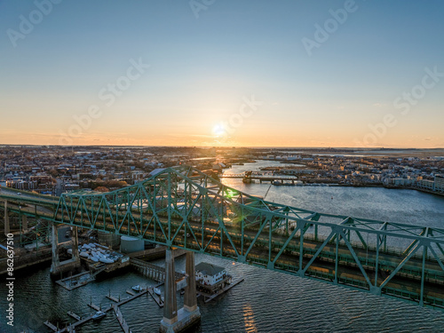 Aerial view of cityscape at sunset with bridge over river, Chelsea, Massachusetts, United States. photo