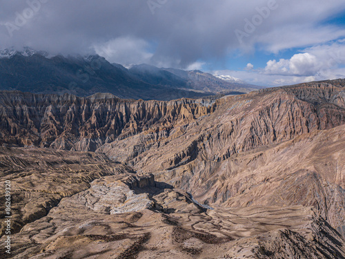 Aerial view of majestic mountains and rugged terrain in Mustang, Nepal. photo