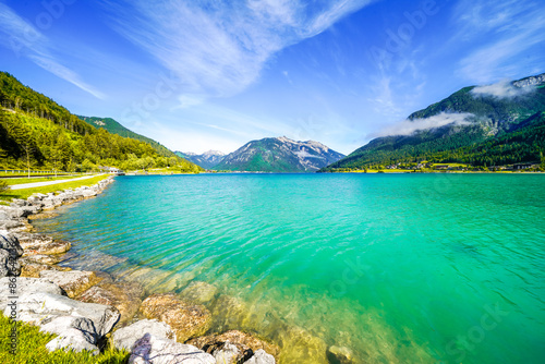 View of Lake Achensee in Tyrol. Nature at the turquoise lake and a mountain landscape in the background. Achental in Austria. 