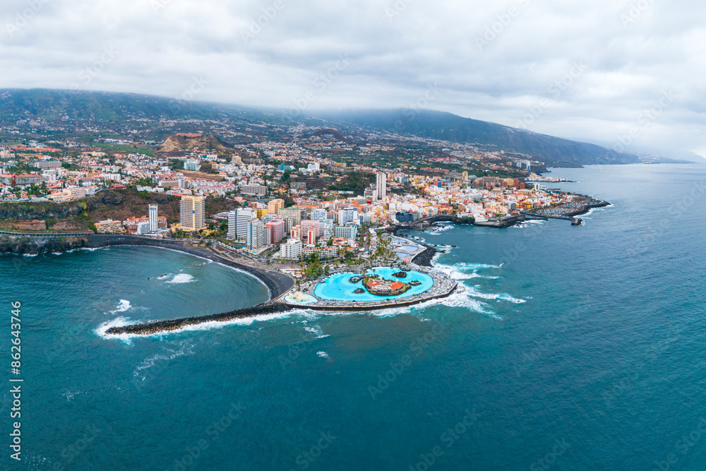 Aerial drone view of Puerto de la Cruz, coastal city and waterpark Martianez on the North of Tenerife island, Spain Aerial drone view of Puerto de la Cruz, coastal city and waterpark Martianez on the North of Tenerife island, Spain
