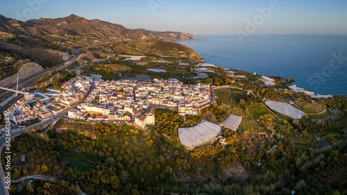 Aerial view of seaside town with mountains and fields, Maro, Andalusia, Spain. photo