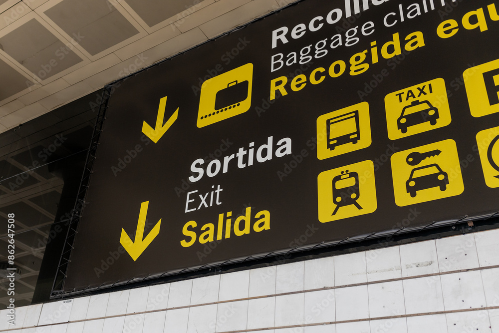 Exit, car rental, bus, train and taxi sign at international airport. Follow the yellow sign at airport