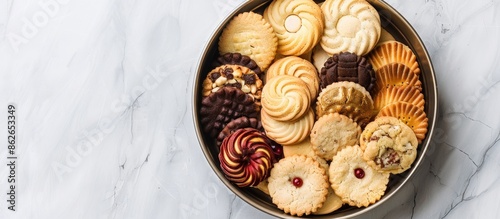 A variety of butter cookies arranged in a tin with copy space image. photo