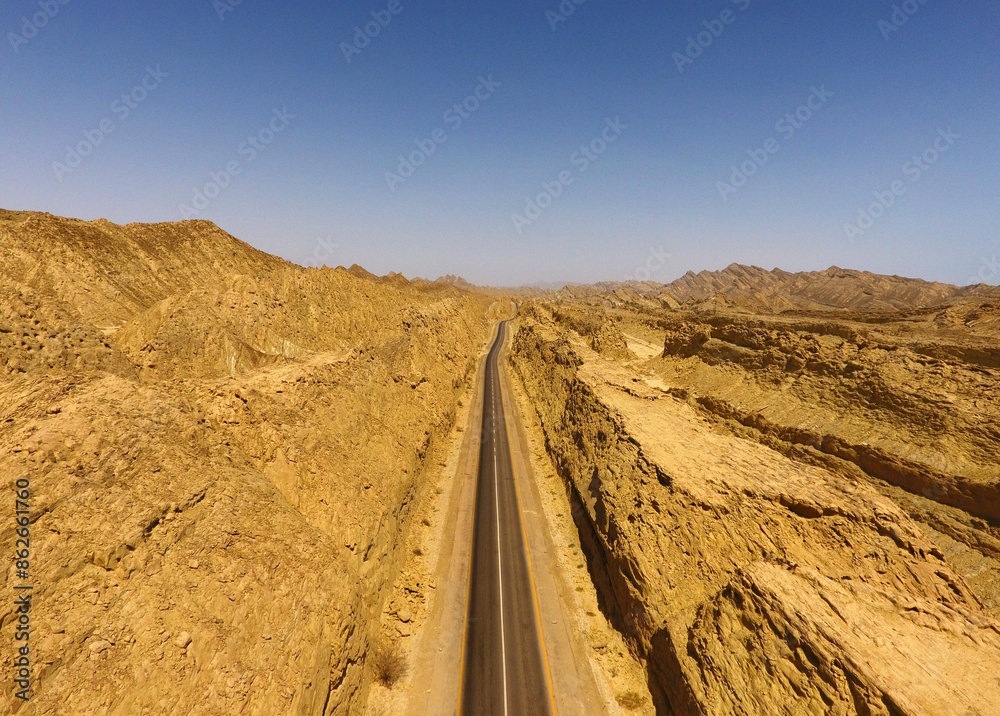 Aerial view of desert road winding through rocky mountains, Ormara, Balochistan, Pakistan. Aerial view of desert road winding through rocky mountains, Ormara, Balochistan, Pakistan.