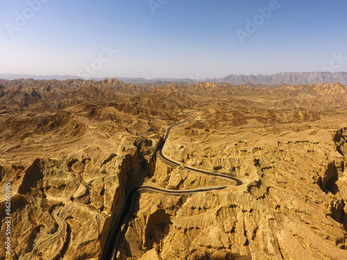 Aerial view of rugged desert terrain with winding road, Balochistan, Pakistan. photo