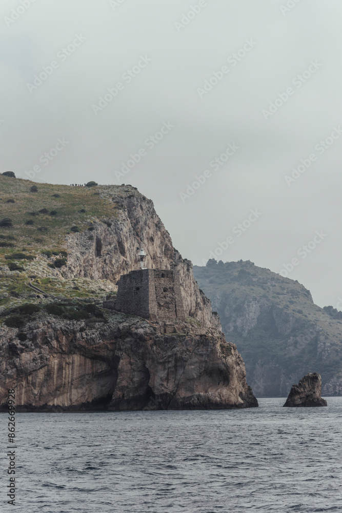 View of rocky cliff and tower overlooking the sea, Amalfi Coast, Baia di Ieranto, Punta Campanella, Italy. View of rocky cliff and tower overlooking the sea, Amalfi Coast, Baia di Ieranto, Punta Campanella, Italy.