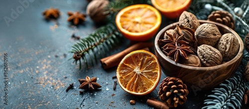 Rustic style bowl with winter food elements like nuts, oranges, cinnamon, and star anise, creating a cozy atmosphere with copy space image.