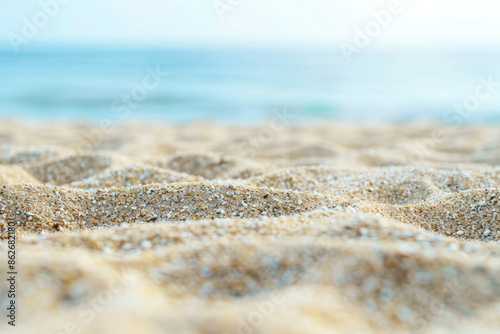 Close up sand with blurred sea sky background.