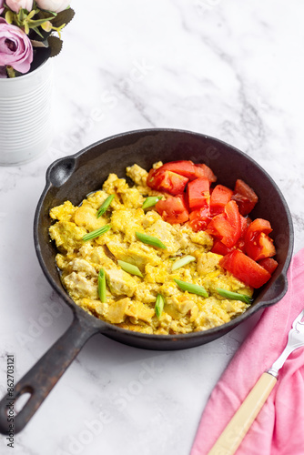 Scrambled tofu with garlic greens and fresh tomatoes