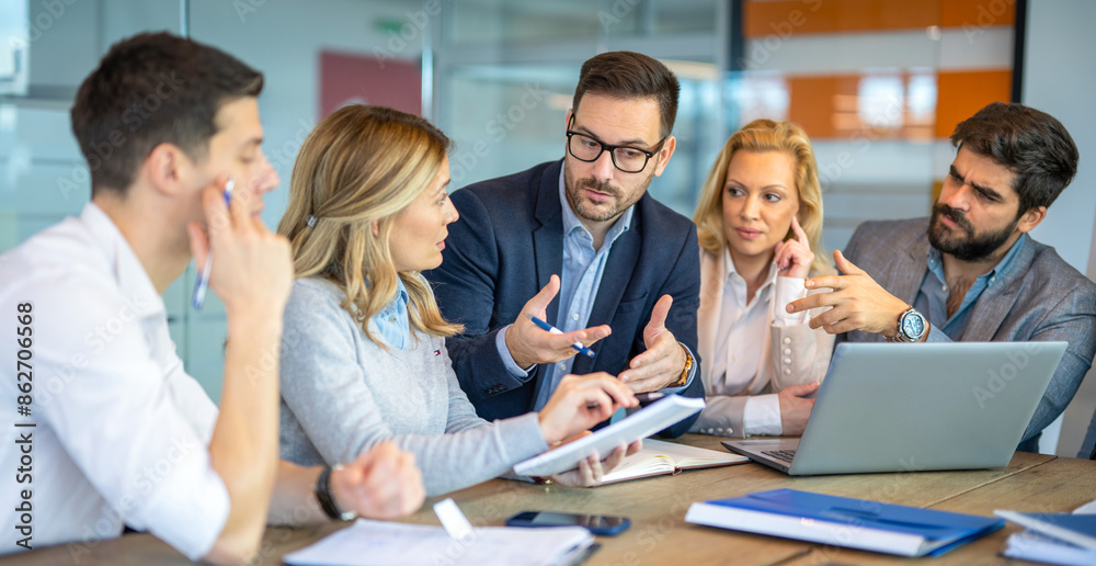 CEO manager explaining to business associates how to overcome the company's crisis by presenting new ideas during a meeting in the conference room. CEO manager explaining to business associates how to overcome the company's crisis by presenting new ideas during a meeting in the conference room.