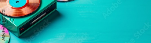 vintage turquoise record player with vinyl records on a teal background - retro music and audio equipment concept. photo