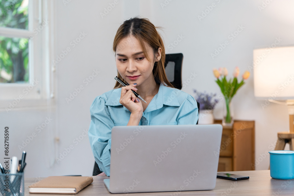 Young Professional Woman Working Remotely from Home Office with Laptop and Notepad
