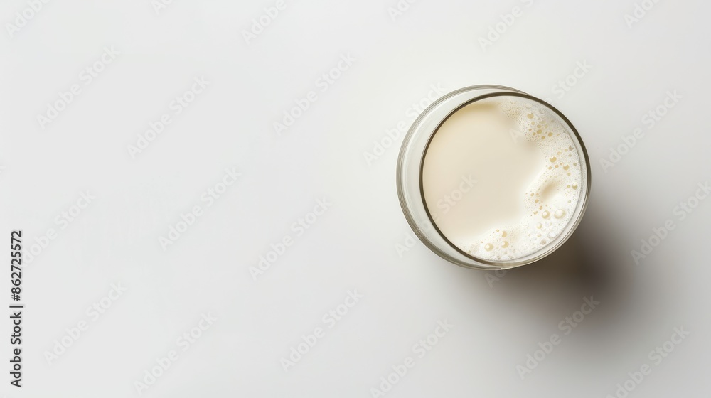 Fresh milk in a glass isolated on a white background seen from above Fresh milk in a glass isolated on a white background seen from above