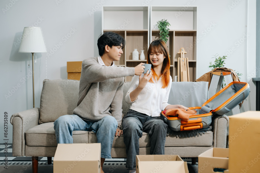 Happy asian young attractive couple man and woman with big boxes moving into a new house, new apartment Happy asian young attractive couple man and woman with big boxes moving into a new house, new apartment